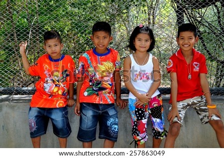 Hua Hin, Thailand - December 31, 2009:  Four young children wearing clothing with western themes at the Khao Hin Lek Fai (Flintstone Mountain) lookout viewpoint