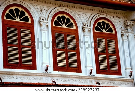 Melaka, Malaysia - December 28, 2006:  Finely restored Chinese shop house with three fan windows and wooden louvered shutters on Jonker Walk