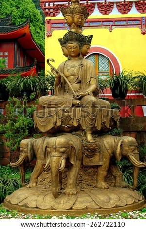 Emeishan, China - April 26, 2005:  Four-faced Buddha statue sitting atop four bronze elephants in front of Wu Lian Hall at the Wan Nian Buddhist temple on Mount Emei