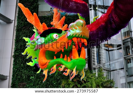 Bangkok, Thailand - January 23, 2013:  A giant Chinese Lunar New Year dragon hangs in the entrance atrium at the upscale Siam Paragon shopping center