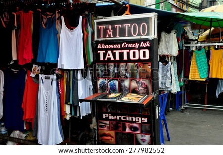 Bangkok, Thailand - December 17, 2012:  Tattoo and piercing shop\'s display sign at a clothing boutique on touristy Khao San Road