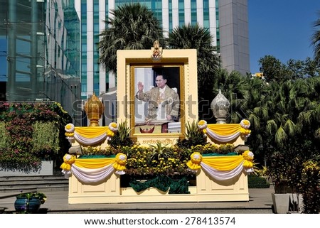 Bangkok, Thailand - December 31, 2011:  Tribute to King Bhumibol in honor of his 84th birthday on December 5, 2011 in front of an office tower on Sukhamvit Road