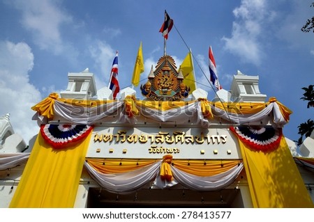 Bangkok, Thailand - December 16, 2008:   Entrance gate into to Silkaporn University (Wang Tha Phra) opposite the Grand Palace with Thai flags and patriotic bunting