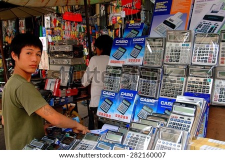 Bangkok, Thailand - December 20, 2005:  Thai youth selling Casio adding machines at an electronics store on Thanon Yaoworat in Chinatown