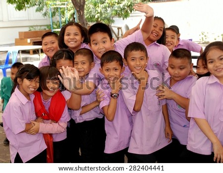 Bangkok, Thailand - December 17, 2006:  A group of smiling Thai school children on a field trip to Buddhist Wat Pathum Wanaram