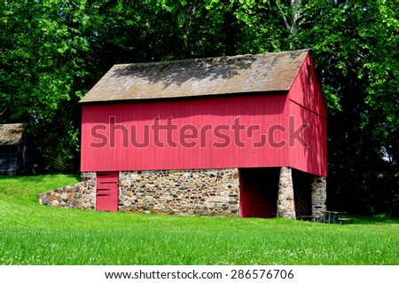 Chadds Ford, Pennsylvania - June 8, 2015:  Fieldstone and red wooden barn at the Gideon Gilpin House in Brandywine Battlefield National Historic Park