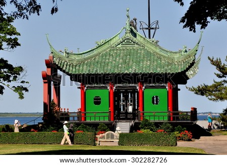 Newport, Rhode Island - July 16, 2015:  The Chinese Tea house with ceremonial gate overlooks the sea on the grounds of 1892 Marble House