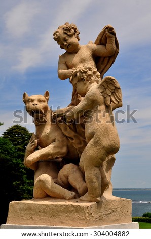 Newport, Rhode Island - July 17, 2015:  Classical statuary with cupids in the gardens at 1898-1902 Rosecliff Mansion built for Theresa Oelrichs *