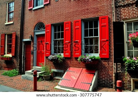 Philadelphia, Pennsylvania - June 25, 2013:  18th century colonial brick home with red fan doorway dating from 1703-1736 on historic Elfreth\'s Alley
