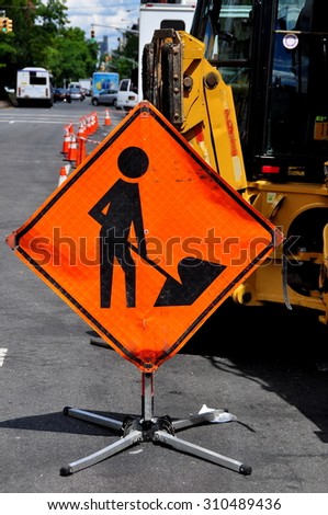 New York City - August 13, 2015:  Orange men at work sign at a Con Edison construction site on Broadway and West 145th Street