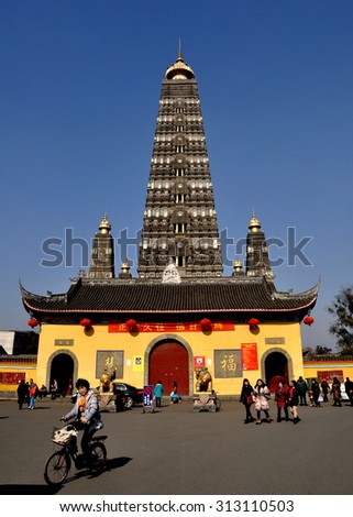 Pengzhou, China - January 20, 2014:  The 22 story Long Xing Pagoda flanked by four satellite pagodas is the city\'s primary Buddhist temple