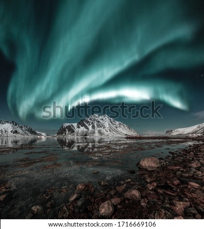 Northern lights, Aurora borealis over amazing landscape in Lofoten, Norway  with mountains in background, Absolutely stunning and beautiful lights on the sky