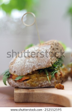 Bombay masala sandwich with chicken, rocket and green salad.