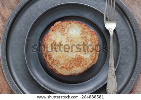Five pieces of potato pancakes on a tin plate.