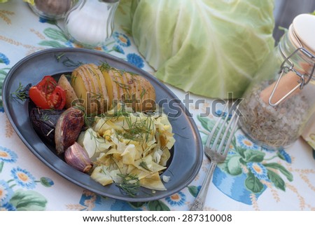 Closeup of cooked cabbage and roasted concertina potato.