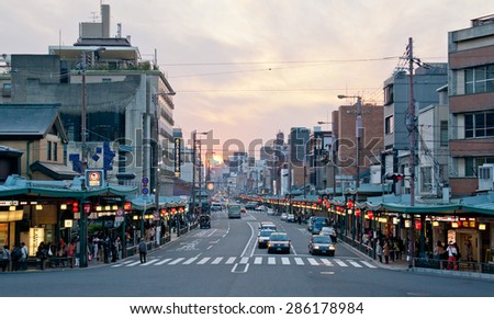KYOTO, JAPAN - March 24, 2014:  Taxi driver works in heavy traffic on shijo dori road at sunset March 24, 2014. Japan is among most motorized countries worldwide, which causes heavy traffic.
