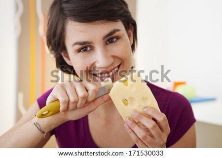 Similar – Image, Stock Photo Smiling woman cutting cheese for salad in kitchen