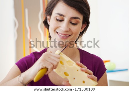 Similar – Image, Stock Photo Smiling woman cutting cheese for salad in kitchen