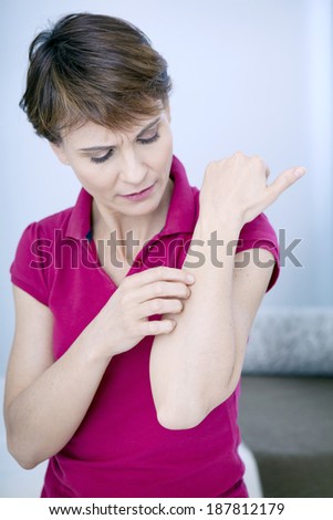Woman itching her arm