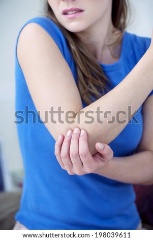 Woman suffering from elbow pain.