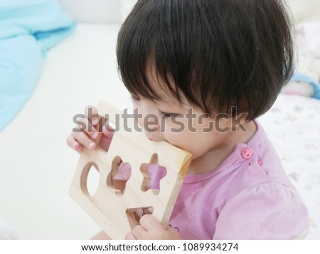 Similar – Image, Stock Photo 13 month old baby trying to navigate a ladder at a playground; reaching and pulling up to tip toes