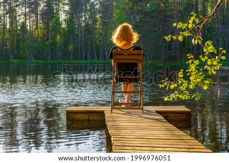 Wooden planked footway in calm evening lake