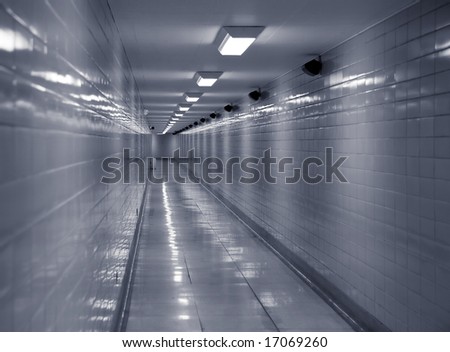 Long clean, cold looking corridor lit by fluorescent lights