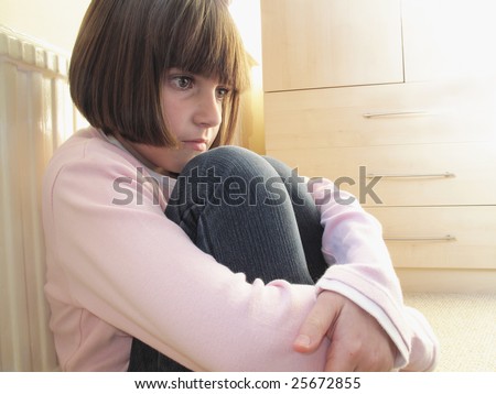 Young Girl Sitting Down With Knees Curled Up Looking Depressed Stock ...