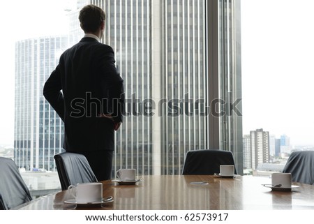 Single adult business man waiting for meeting to begin in Board room