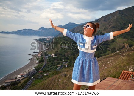Free Happy Woman Enjoying Nature. Woman relaxing at the terrace with arms open enjoying her freedom.