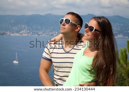Portrait of an beautiful young couple hugging, enjoying vacation by the sea. Forever together, honeymooners in France Riviera.