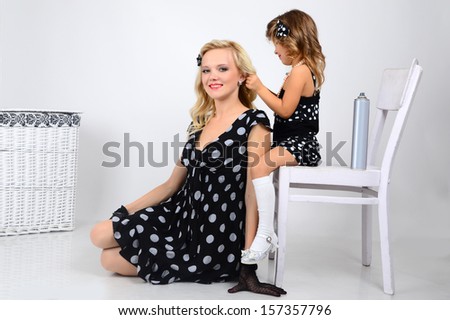 Mom and daughter polka dot black and white dresses back to back