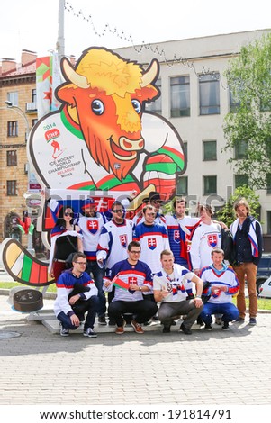 Minsk, Belarus - May 9,2014: Fans of Slovakia Ice Hockey team taking picture with Ice Hockey World Championship 2014 symbol Bison Volat on the street