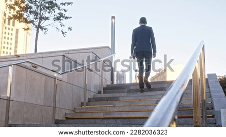 Similar – Image, Stock Photo Unrecognizable traveler walking up hill along road