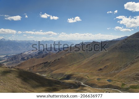 Aerial view to desert mountains with river and lake