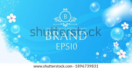 Soap foam with flowers on blue background. White transparent lather with bubbles. Fresh and clean product adverticing.