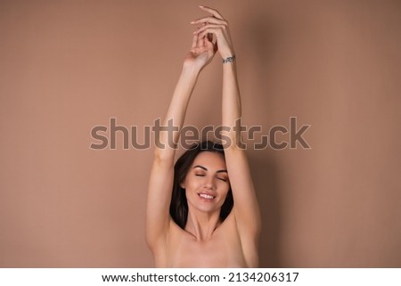Similar – Image, Stock Photo A topless woman from her flat window is showing her perfect sexy curves and drinking from some kind of a canister that shines red light. It enlightens her beautiful body and pretty face. The city is going to sleep.