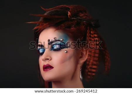 beautiful pretty female face with multicoloured eyeshadow - close-up