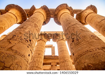 EXPLORING EGYPT - KARNAK TEMPLE - Massive columns inside beautiful Egyptian landmark with hieroglyphics, and ancient symbols. Famous landmark in the world near the Nile River and Luxor, Egypt