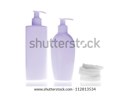 set of cosmetic bottles with cleaning pads isolated on white background