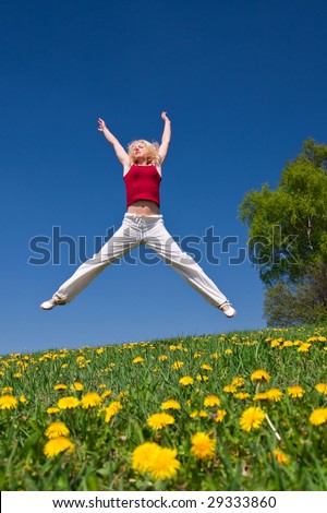 young woman having fun on a flowery meadow