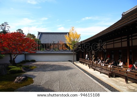KYOTO - NOV 21: Visitors of Nanzen-ji  temple contemplating zen garden on November 21 2009 in Kyoto, Japan. The autumnal spectacle of red maple trees attracts large crowds in zen gardens of Kyoto.