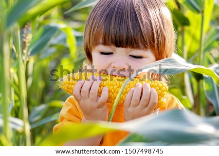 Similar – Foto Bild Kind hält Mais in der Hand und wirft weinend den Kopf nach hinten