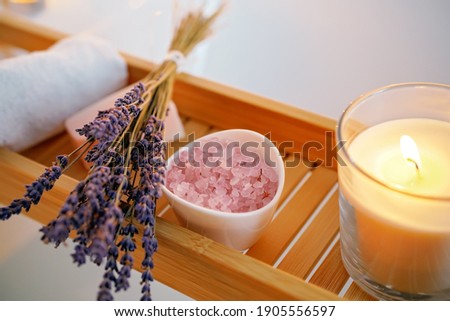 Spiritual aura cleansing ritual bath for full moon ritual. Candles, aroma salt and lavender on tub table, close up Stock fotó © 