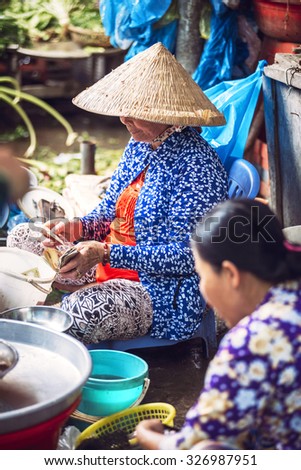 Hanoi, Vietnam - January 20, 2014: Vietnamese street market seller, on January 20, 2014, in Hanoi, Vietnam