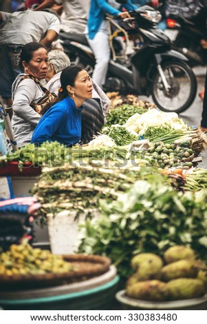 Hanoi, Vietnam - January 20, 2014: Vietnamese street market seller, on January 20, 2014, in Hanoi, Vietnam