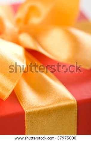 Close up on red, gift box with gold ribbon