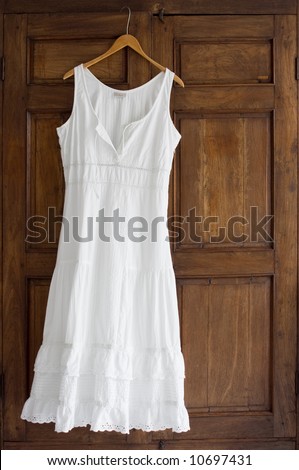 White Cotton Dress On Wooden Hanger On Antique Wardrobe Stock Photo ...
