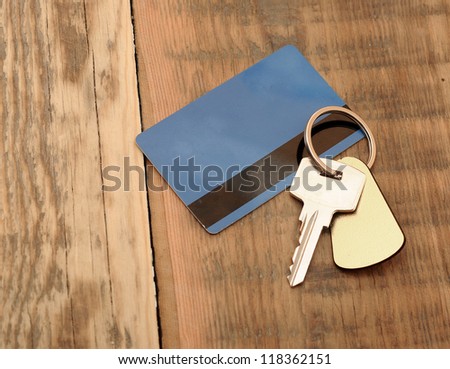key with plastic card on wooden background