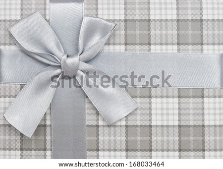 gift box with silver ribbon and bow isolated on white background, top view